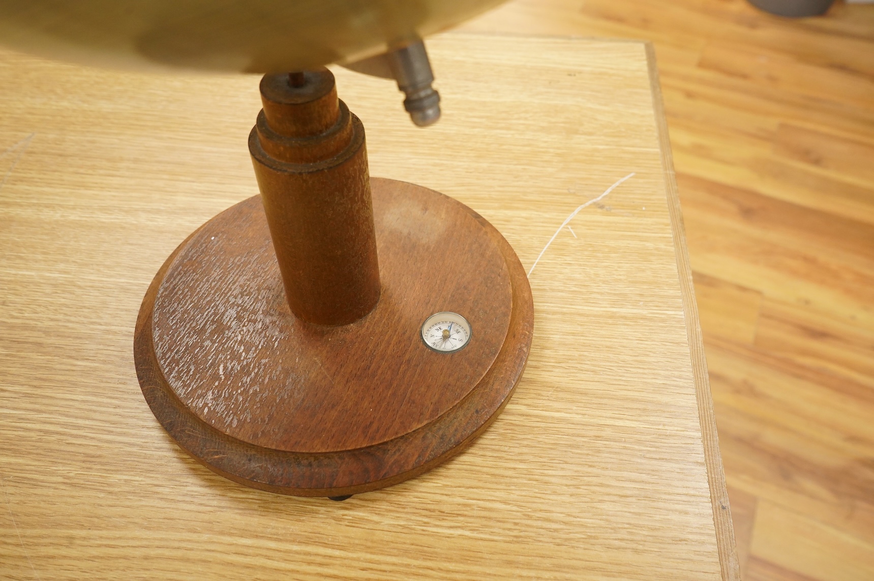 A mid 20th century 12 inch terrestrial globe on an oak base with integrated compass, the globe printed with; ‘Printed in Germany’, overall height 55cm